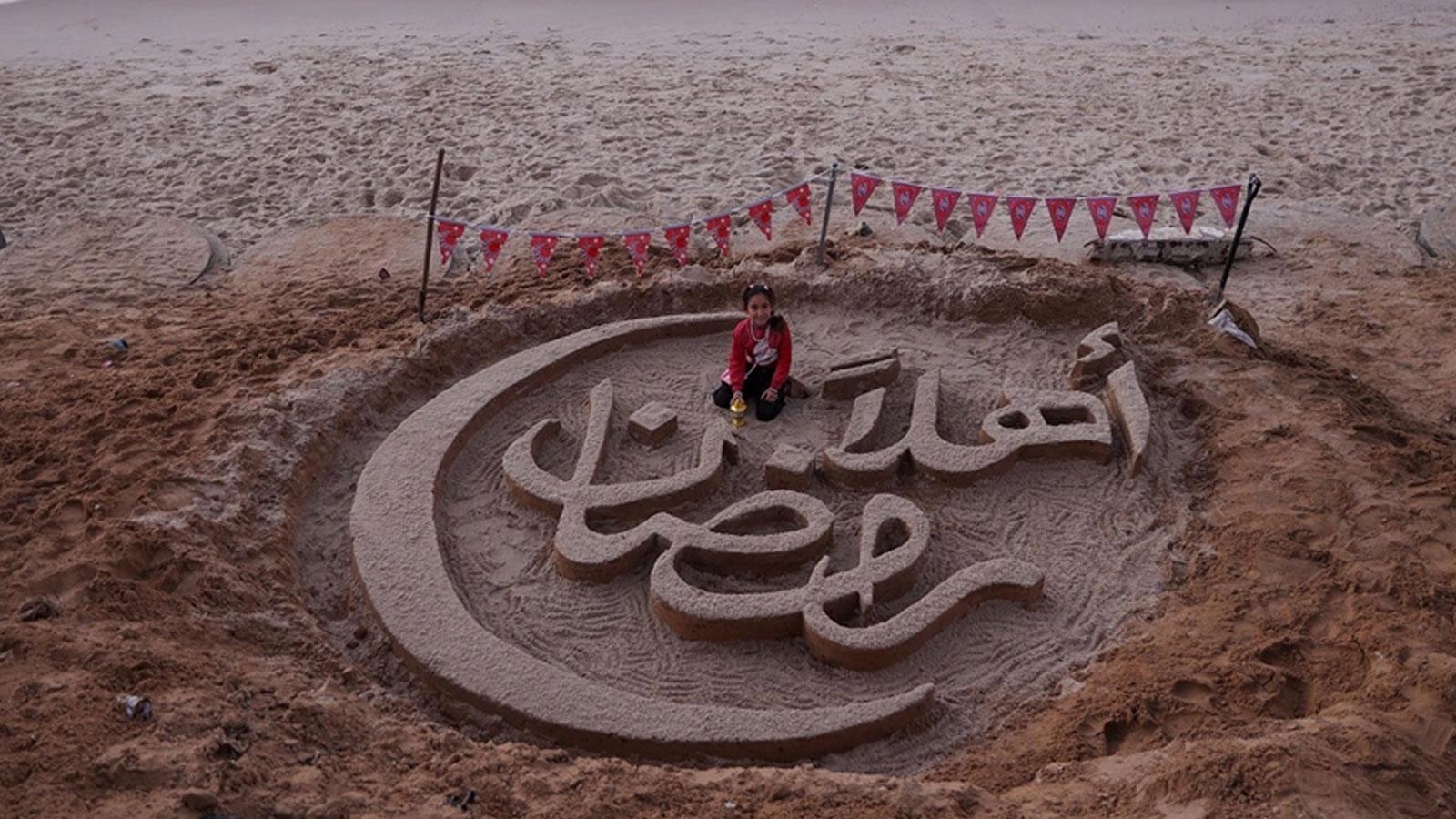 Gazzeli sanatçı sahilde "Hoş geldin ramazan" yazısıyla umudunu yansıttı